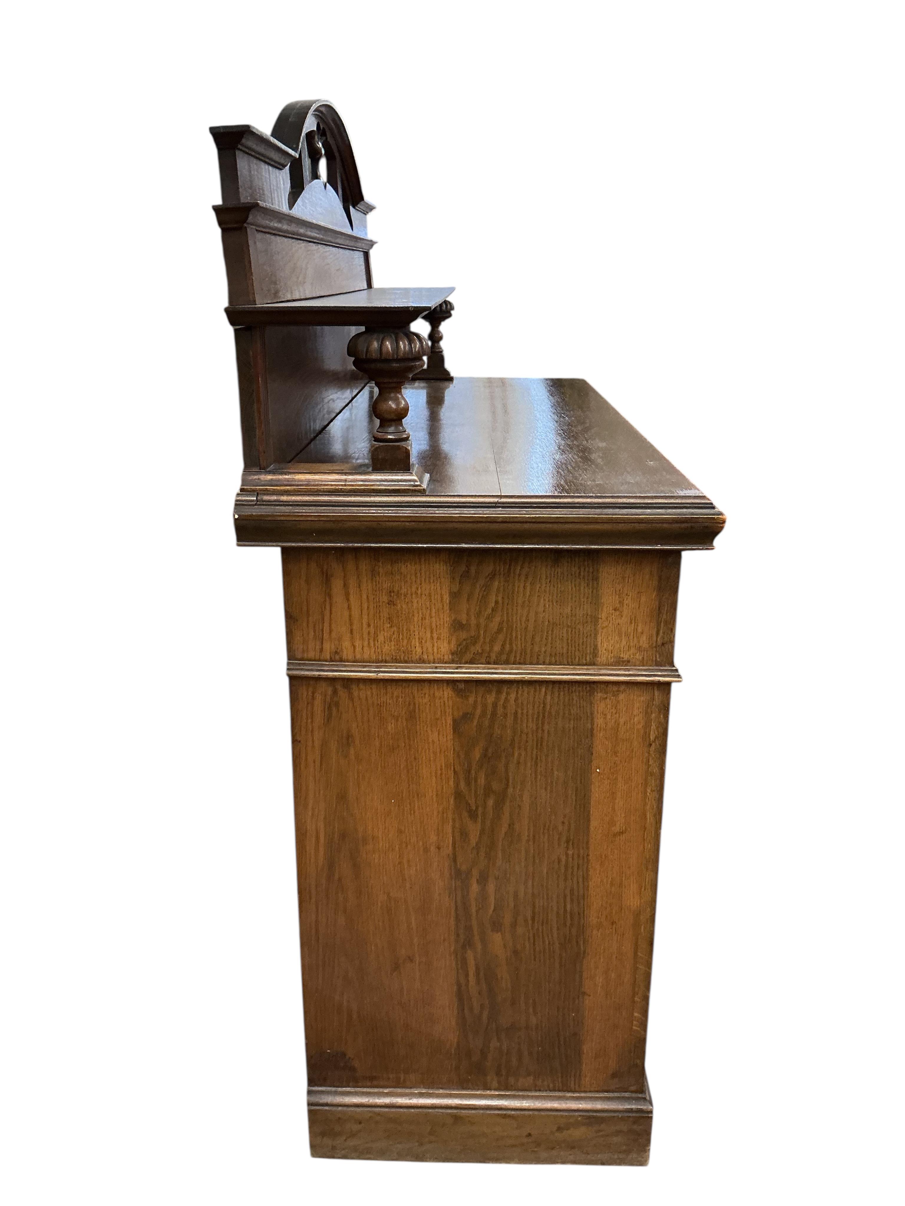 A late Victorian Art Nouveau oak sideboard, width 137cm, depth 54cm, height 140cm